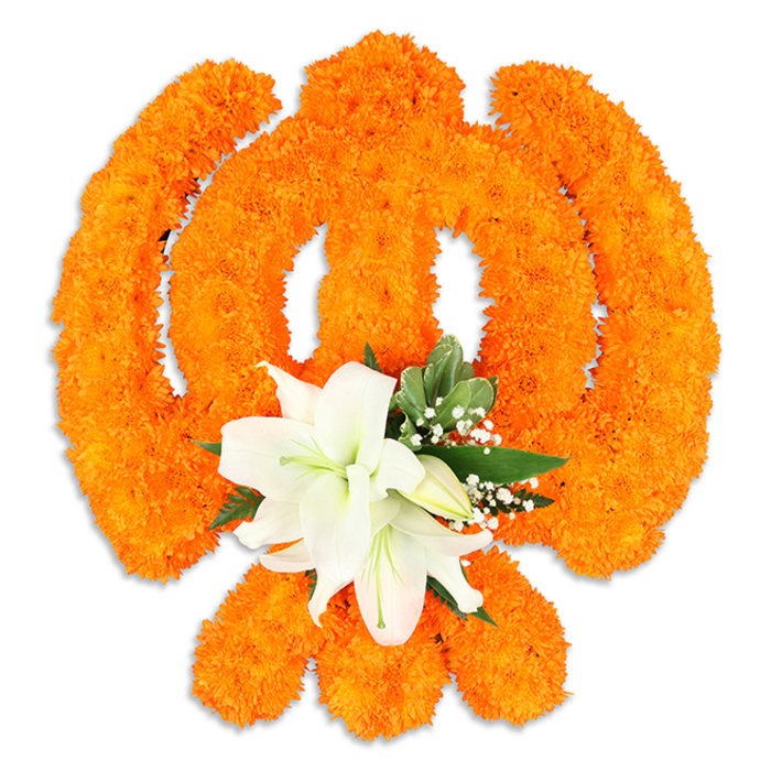 Set against a pristine white field, this floral Ik Onkar/Khanda-inspired composition is a study in contrast and reverence: a precise emblem shaped from a dense mosaic of vivid orange marigold blooms, each tiny flower head locked close to its neighbour to create a continuous, luminous surface. The emblem's defining lines-the circular chakkar, the intersecting blades and the central khanda-are modelled with remarkable symmetry, the marigolds' warm, almost sunlit hue suggesting celebration and collective devotion. Anchoring the arrangement is a cluster of elegant white lilies positioned at the lower central area where the emblem's elements converge; their fully opened petals arc outward, revealing pale green centers and slender yellow stamens, while nearby lily buds and sprays of delicate baby's breath add graduated notes of softness. Rich green foliage, with glossy, pointed leaves, frames the lilies and cuts a cool contrast to the marigolds' intensity, offering visual breathing room and a natural cadence to the design. The faint drop shadow beneath gives the piece a subtle sculptural presence, as if the work were placed on a polished plinth in a gurdwara foyer. As a floral designer who often prepares ceremonial pieces for north London communities, I imagine this displayed with understated dignity at Guru Nanak Jayanti or a community puja close to Fortess Road or the shops around Tufnell Park Road; the composition balances the joyful orange of celebration with the lily's quiet serenity to create an offering that feels both communal and deeply personal.