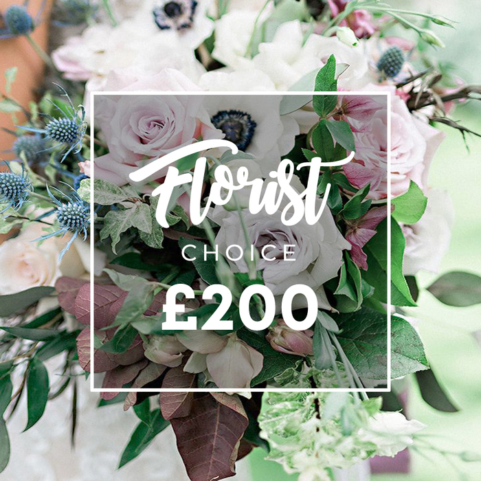 Seen in a high-quality close-up photograph, this premium Florist Choice bouquet, priced at ?200, is arranged to spotlight texture and craft. The blooms mingle soft pastels and muted tones: open light pink garden roses with their many petals, ivory-white and pale lavender-grey roses, and crisp white anemones with dark centers that provide a striking focal point. A sculptural note comes from blue eryngium thistles, their spiky, star-like forms contrasting with the petals, while the greens-eucalyptus-like leaves and darker burgundy foliage-create movement and depth.

Overlaying the center is a semi-transparent white square that displays Florist Choice and the price in white on a clean, modern frame, like a gallery label. The softly blurred background hints at an outdoor venue or sunlit studio near Archway, Kentish Town, or Dartmouth Park, where this arrangement could anchor a wedding reception, a refined anniversary, or an elegant home centerpiece. Handcrafted by a local florist with a keen eye for seasonal stems, this bouquet embodies the craft and trust of the Tufnell Park floral scene, available for delivery across N19 and nearby areas, bringing a touch of luxury to everyday life.