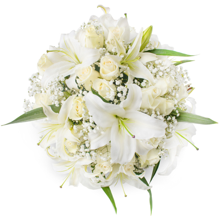 Captured from directly above on a crisp white background, this round bouquet is an exercise in monochrome nuance: large white lilies open with graceful trumpets and visible stamens, a few of which display a whisper of light green and even faint purple at their throats, giving points of interest within the pale palette. The lilies' broad, satiny petals contrast with the compact, layered forms of cream and ivory roses, many kept in near-bud form to present tight, velvety spirals that add depth and a plush tactile feel. Fine sprays of Baby's Breath (Gypsophila) are distributed through the arrangement, their tiny starry flowers producing a soft, cloud-like veil that prevents any hard gaps and contributes a delicate filigree texture around the larger blooms. Trim, verdant leaves peek out strategically at the bouquet's margins and between blossoms, providing a fresh green outline that keeps the composition lively and natural. Lighting is soft and diffuse, highlighting petal translucency and casting gentle shadows that reveal the bouquet's three-dimensional form despite the flat overhead angle. The overall mood is pure and serene-this is a design that speaks of new beginnings and solemn beauty, suited to weddings, christenings, or refined memorial displays in the local area. Locally minded clients often choose this arrangement for ceremonies and receptions around Tufnell Park tube, Junction Road and the quieter lanes near Dartmouth Park because its clean lines and timeless palette photograph beautifully in both daylight and indoor settings.