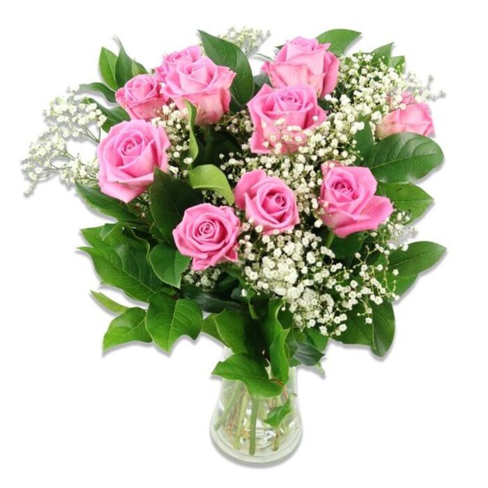 In this photograph, a clear glass vase holds a rounded bouquet of pink roses and white baby's breath, all set against a clean, bright white background. The roses, numbering roughly ten to twelve, form the central mass of the arrangement, their petals unfolding in layered whorls that are soft to the eye and easy to imagine as velvety to the touch. The colour palette centres on gentle pinks: some blooms display a delicate, almost pastel wash, while others reveal a more medium, rosy hue concentrated near the centre, creating a sense of depth and natural variation. Nestled among the roses, sprays of baby's breath stretch out in fine, branching lines, each tipped with numerous tiny white blossoms that give the impression of clouds or a fine mist settled among the larger flowers. Encircling the blooms, dark green leaves provide structure and contrast, their smooth surfaces and defined edges framing the pastel roses without dominating them. The stems, clearly visible through the transparent glass and water, are cut at coordinated lengths yet arranged with a slightly organic spread, reflecting the skilled but relaxed style of a local Tufnell Park florist. The lighting is bright and even, revealing each curve and fold without harshness, and the white background gives the composition a fresh, modern feel. Overall, the bouquet conveys tenderness, warmth, and quiet joy-qualities that make it ideal for welcoming a new baby into a Tufnell Park home, marking a baby shower, or sending heartfelt congratulations to new parents in the surrounding North London streets and terraces.