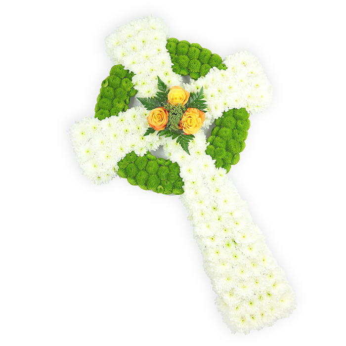 A meticulously assembled Celtic cross made from fresh flowers occupies the frame, its three-dimensional silhouette presented against a bright white backdrop that accentuates each colour and texture. The primary massing is of compact white spray chrysanthemums, their multitude of small heads forming a soft, cushiony surface across the cross's arms and long stem; the effect is one of purity and serene volume. Contrasting bands of near-lime, apple-green button chrysanthemums are precisely placed to delineate the circular ring at the cross centre and to alternate within the horizontal arms, creating the knot-like geometry associated with Celtic iconography and adding a lively, almost tactile rhythm to the surface. At the central intersection, a tight cluster of three vivid orange-yellow roses commands attention; their warm petals, slightly open, glow like a central sun and are gently framed by darker green fern or foliage sprigs that give the focal point weight and natural definition. The lighting is soft and neutral, bringing out petal detail without harsh shadows, while the stark white background keeps the composition pure and contemplative. This piece reads as an elegant funeral or sympathy tribute, particularly resonant for those wishing to acknowledge Irish roots or Celtic faith - its colours subtly echoing the Irish palette. Crafted with the precision of a neighbourhood florist familiar with services in Tufnell Park and nearby Dartmouth Park, it balances solemnity and a quiet, comforting optimism.