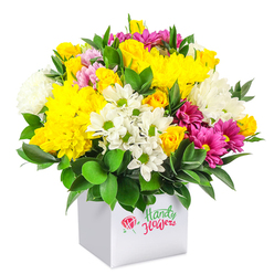A rounded, abundantly packed bouquet of mixed seasonal flowers rises from a clean white cube box, set against a white studio-style background that lets each bloom in the design take centre stage. The colour palette is dominated by warm yellows, fresh whites and bold fuchsia tones, braided together with rich, dark green foliage to create a joyful, almost celebratory energy. Plush yellow chrysanthemums anchor the piece, their layered petals forming generous, domed flower heads that catch the light, like little suns glowing over the streets of Tufnell Park. Around them, clusters of small yellow spray roses and delicate rosebuds peek out, some still tightly furled and others just starting to unfurl their petals, giving a sense of movement and new beginnings. White daisy-like chrysanthemums, each with a distinct green centre, bring a simple, cheerful charm, while fuller white mums introduce extra softness and depth. Scattered between are vibrant fuchsia and magenta chrysanthemums, some gently shading into lighter pink, creating lively colour accents reminiscent of the colourful market buckets you might see outside a florist near Tufnell Park Road. The foliage is lush and glossy, with sturdy deep green leaves cradling the blossoms and forming a natural frame that highlights the brightness of the flowers. The box itself is minimal and modern, acting as both vase and gift packaging, practical for delivery to flats and townhouses around Dartmouth Park and Kentish Town. The overall mood of the arrangement is upbeat and welcoming, well suited as an affordable yet impactful floral gift to say thank you, happy birthday, or simply "I'm thinking of you" to someone in North London.