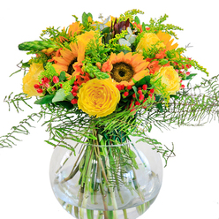 Evoking the optimism of a new day in Tufnell Park, this joyful bouquet brings together the golden faces of sunflowers, each radiating cheer with their bold yellow-orange petals arched around velvety brown centers. These radiant blooms are complemented by swirls of yellow garden roses, tightly layered and plush to the touch, with a look as soft as the light that streams into nearby Victorian homes. Scarlet clusters of hypericum berries are laced through the arrangement, their shine reminiscent of laughter shared in the leafy lanes off Brecknock Road. The bouquet's edges are softened by ethereal wisps of green foliage-delicate, fernlike fronds and filler with hints of tiny golden blossoms referencing goldenrod-while slender eucalyptus leaves add an aromatic, gently cooling accent. Every element is gathered artfully in a crystal-clear, spherical vase, where the tangle of green stems is visible beneath the sparkling water-like a window into a well-loved Tufnell Park garden after rainfall. With its harmonious blend of bold and delicate, this arrangement brings a sense of togetherness and celebration, ideal for marking milestones, brightening a weekend brunch on Junction Road, or simply uplifting a space with the unmistakable vibrancy of North London living.