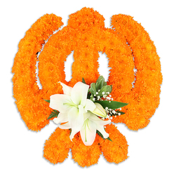 This arrangement translates a sacred emblem into living flowers: the Khanda emerges in relief as thousands of bright orange marigolds are clustered to form the central chakkar, the two crossed kirpans and the upright double-edged khanda. The marigolds' compact, plush heads give the symbol a richly textured, almost fabric-like surface; light skims their rounded crowns and brings out subtle golden highlights. At the intersection, a concentrated cluster of pristine white lilies provides a calm focal point-two or more fully open blossoms with soft, satin petals, green-tinged throats and delicate yellow-green stamens, ringed by smaller buds that hint at unfolding life. Interlaced sprigs of glossy green foliage and fine sprays of baby's breath create soft transitions between the stark white and the vibrant orange, while the clean white background and a faint drop shadow emphasize the piece's three-dimensional craftsmanship. The scent is imagined here as a warm, peppered sweetness from the marigolds mingling with the cool, green perfume of lilies, a combination that reads as respectful and uplifting. This floral Khanda is designed for ceremonial displays and community remembrance; I can easily picture it greeting visitors in a gurdwara hall or standing as a focal tribute at a Vaisakhi celebration in the Tufnell Park and Archway neighbourhoods. The composition speaks of skilled hands, patient placement and cultural care-a floral statement that honours tradition while remaining approachable and tactile for those who come to observe or reflect.