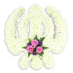 A striking Sikh Khanda floral tribute dominates the scene, set cleanly against a seamless white background so that every detail of the design stands out. The entire symbolic form-the central double-edged sword rising upright, encircled by the smooth ring of the chakkar, and flanked by two curved kirpans-has been meticulously constructed from a dense blanket of white chrysanthemums. Each flower head sits snugly beside the next, creating a plush, cushion-like surface with a soft, feathery texture. Subtle variations of white and pale cream catch the light, giving the arrangement depth without disturbing its serene, unified look. At the lowest point of the tribute, where the blades of the kirpans sweep inward, a jewel-like cluster of colour has been carefully arranged. Three pink roses, their petals gently spiralling open, rest among rich purple blooms and fresh green fern foliage, adding a tender note of comfort and remembrance. The contrast between the quiet white backdrop of flowers and this intimate burst of colour mirrors the balance between solemnity and love that surrounds a Sikh farewell. A faint shadow beneath the Khanda suggests it is slightly raised, emphasising its sculptural quality. This piece feels especially suited to a dignified Sikh funeral or memorial gathering in and around Tufnell Park, perhaps for a service near Tufnell Park Road or Dartmouth Park. It reflects the thoughtful hand of an experienced local florist who understands how to honour both cultural symbolism and personal grief through carefully selected, freshly prepared blooms.