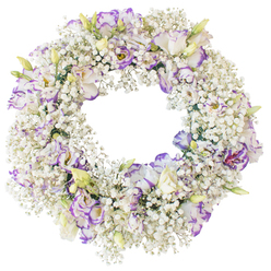 A softly radiant circular wreath is shown in full view against a crisp white background, its surface completely carpeted with tiny white baby's breath blossoms that bring to mind light fog rolling over the streets around Tufnell Park Underground station at dawn. The Gypsophila clusters are packed closely, creating a thick, fluffy ring of texture, each delicate floret catching the light so the whole wreath seems to glow. Scattered generously through this snowy halo are elegant lisianthus flowers, their petals unfolding in ruffled layers of white edged with gentle strokes of lavender and rich purple. Some blooms are wide open, revealing their darker, secretive centres, while others remain partially closed, showing hints of pale green and buttery yellow at the base of the petals, like new growth just emerging in a spring garden off Fortess Road. The mix of the tiny, cloud-like filler and the larger, painterly lisianthus gives the design depth and quiet movement, as though the flowers are breathing. The wreath's open centre is perfectly round and unobstructed, reinforcing the symbolism of the circle-unbroken love, remembrance, and continuity. With no visible stand or surroundings, the arrangement seems to float, every petal and cluster clearly defined against the white backdrop. The mood is calm and contemplative, making it an ideal floral tribute for a funeral or memorial gathering, or for delivery to a family home in Tufnell Park where a gentle, dignified expression of sympathy is needed. The restrained palette of white and soft purple conveys comfort, respect, and a tender farewell. 