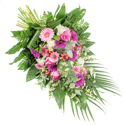 Set against a clean white background, this hand-crafted funeral spray stretches diagonally from the upper left to the lower right, like a final, gentle gesture of farewell. The composition is rich yet serene, filled with a blend of soft pink, fuchsia, purple, and white blooms resting on a bed of layered greenery. Large gerbera daisies in pastel blush and intense magenta act as the emotional anchors of the design, their round faces open and welcoming, much like the community gatherings around Tufnell Park and Holloway Road. Between them, elegant pink roses unfold in tidy spirals, their petals tightly layered, bringing a sense of grace and tradition often chosen for heartfelt tributes. Clusters of white flowers-resembling carnations or small chrysanthemums-add a ruffled, cloud-like texture, while tiny daisy-like filler blossoms dance through the gaps, creating an airy, almost whimsical pattern that softens the overall look. Here and there, bright red hypericum berries peek out, adding small bursts of colour and a natural, berry-like shine. The foliage is carefully composed: broad, glossy dark leaves provide structure, delicate fern fronds fan outward with feathery lightness, and cool, silvery eucalyptus leaves curve through the flowers, suggesting a fresh, calming scent. Long, slender palm leaves sweep from the lower right, emphasising the flowing, cascading movement of the arrangement. At the top left, the bound green stems are intentionally left visible, hinting at the craftsmanship behind the piece. Ideal as a casket spray or a major tribute for a funeral service in Tufnell Park or nearby Kentish Town, this arrangement expresses comfort, respect, and loving remembrance, suitable for same-day delivery to local chapels and funeral homes.