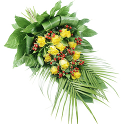 Set against a clean, brilliant white background, this elongated funeral spray captures the gentle elegance of yellow roses arranged by a local Tufnell Park florist. The design flows diagonally from the top left to the lower right, where it tapers into a soft point, creating a teardrop-like silhouette that feels both graceful and serene. At its centre, a generous gathering of around fifteen to twenty yellow roses forms the focal line, each bloom at a different stage of opening: some petals remain tightly cupped, while others unfurl in soft spirals, revealing warm, golden hearts that suggest comfort and remembrance. Nestled between the roses are clusters of polished red Hypericum-style berries, their round shapes and deep ruby tones adding texture and a quiet richness that contrasts beautifully with the sunny petals. The foliage is abundant and thoughtfully arranged, with wide, dark green leaves folded and layered at the top left, providing structure and a strong, dignified base. From the bottom right, long, slender palm fronds stream outward in a fan-like sweep, their fine, pointed leaflets introducing a sense of lightness and gentle movement, almost like a final, tender gesture of farewell. Each leaf catches the soft light, revealing subtle variations of deep and mid green, while the berries reflect a slight sheen. The stems are tightly bound, indicating professional craftsmanship suited for a funeral cortege making its way through the quiet streets around Tufnell Park Road or Junction Road. This refined spray, with its interplay of yellow roses, red berries, and layered greenery, offers a heartfelt tribute for services and memorial gatherings across Tufnell Park and nearby Gospel Oak.