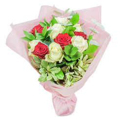 Capturing the spirit of Tufnell Park's close-knit community, this artful bouquet combines sumptuous red and white roses with an opulent flourish of seasonal greenery. The white roses glow with the purity of new beginnings, their petals unfurling like soft clouds drifting above the rooftops along Tufnell Park Road. In contrast, the velvety reds convey ardour and celebration-a nod to the vibrant energy found at the local markets and hidden gardens nearby. Sprigs of lustrous ruscus, round leaves with a juicy sheen, and fine threads of eucalyptus glisten throughout, adding texture and grounding the vivid blooms in a sense of the real, thriving nature that frames the area. Everything is lovingly enveloped in a translucent layer of blush pink paper, the wrapping echoing sunset light filtering through community park trees. Every detail, from the delicate veining on the foliage to the gentle curve of each petal, speaks to the knowledge and devotion of a florist who knows what flowers mean to a local patron. This bouquet is a perfect companion for anniversaries, birthdays, or quiet moments of reflection, radiating both contemporary luxury and timeless sentiment-much like Tufnell Park itself.