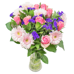 Arranging this bouquet in our Tufnell Park shop, I am continually drawn to the interplay between blush gerberas and blush-pink roses. Their colours blend together in an almost watercolor harmony, reminiscent of the soft spring light that spills onto our streets from the gardens of Tufnell Park and the historic paths of nearby Kentish Town. Vivid purple statice adds a lively rhythm, punctuating the pastel blooms and evoking the creative spirit of local markets and community events. The fresh green leaves, cool and full of life, provide a base that grounds the airy composition, much like the green spaces threading through Tufnell Park. Set in clear glass, the stems ripple in water, the entire arrangement glowing gently as if illuminated by morning sunlight through a Highgate window. Designed for joyful moments-a cheerful get-well, a stylish accent for a bright Tufnell Park flat, or simply to add an optimistic note to an ordinary day-this bouquet radiates care and natural beauty. Every element is chosen for meaning and freshness, offering a sensory reminder that every day in Tufnell Park deserves a small celebration.