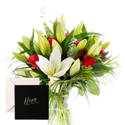 This bouquet is a portrait of sophistication and emotion, carefully composed to evoke both admiration and quiet comfort. The white lilies are large and trumpet-shaped, with creamy petals that stand proud against a backdrop of lush green spears and curling foliage. Red roses punctuate the arrangement with a deep, heartfelt warmth, their perfume mingling with the lilies in a dewy, hypnotic balance. The overall effect is refined and generous, with clean lines and generous space around each bloom that lets the bouquet breathe while maintaining a confident arc.

Unopened buds promise beauty yet to come, hinting at ongoing celebration and hopeful horizons. Light is bright and natural, tracing the edges of every petal and leaf, so the arrangement reads as both present and promise. This is a gift that feels equally suitable for remembrance as for gratitude-elegant, timeless, and emotionally resonant.

Wrapped with an elegant card marked Hero, this creation carries a personal tribute meant to endure. For those in and around Tufnell Park-Archway, Holloway Road, and Kentish Town-the bouquet is ready for same-day delivery, proudly offered by Flowers Tufnell Park to homes and workplaces alike.

Delivered in a simple clear glass vase, the arrangement rests with quiet assurance, the blooms glowing against a backdrop of emerald leaves. It is a sophisticated, enduring gesture-an invitation to pause, reflect, and celebrate the extraordinary people who brighten our days in north London.