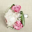 Nestled against a muted canvas reminiscent of the welcoming spaces in Tufnell Park, this bouquet whispers of romance and joyful new beginnings. A trio of vivid pink roses, each meticulously unfurled and shaded from bold fuchsia at their tips to delicate, creamy blush and lavender at the centre, sits entwined in a billowing cloud of ruffled white peonies. The peonies, lush and full, bring an ethereal softness as if touched by morning light drifting over Tufnell Park's leafy lanes. Dainty sprigs of baby's breath-each a tiny constellation of white-thread through the flowers, imparting an airy, almost magical quality that calls to mind spring blossoms along Fortess Road. The encircling leaves, glossy and emerald-hued, frame the bouquet crisply, their folds providing both structure and modern flair. A hand-tied white satin ribbon, wrapped with just the right tension, completes the design-ready to be delivered with care by local florists for a wedding, engagement, or anniversary in Tufnell Park. The composition, both structured and free-flowing, evokes gentle fragrance and timeless elegance; it is a living embrace of affection, expertly crafted to highlight the character and warmth that make this neighbourhood unique.