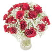 A luminous, classic bouquet of roughly eighteen to twenty deep crimson roses nestled within a cloud of delicate white baby's breath (Gypsophila paniculata), photographed against a clean white backdrop. The roses are fully open, their velvety petals spiralling to reveal rich, saturated red tones that catch soft, even light; tiny dew-like highlights lift the surface of each petal and make the crimson appear almost tactile. Around and between the blooms, the frothy sprays of gypsophila float like mist, their miniature star-shaped blossoms offering an airy counterpoint that softens the intensity of the roses and creates a romantic, harmonious silhouette. The arrangement sits in a clear glass vase so transparent that the long, verdant green stems are plainly visible, the straight stalks and occasional leaf providing a grounded, organic rhythm beneath the dome of flowers. The composition reads as both sumptuous and restrained-lush yet compact, the roses arranged with careful spacing so each bloom breathes, while the baby's breath fills negative space with whisper-light texture. A subtle rose fragrance seems to hang above the bouquet, mingling with the faint, sweet chalkiness of the gypsophila; the overall mood is tender and intimate, suited to anniversaries, quiet declarations of love, or to make an ordinary day feel ceremonious. For anyone in the Tufnell Park area, this design evokes local comforts-a neighbourhood floral classic that pairs as naturally with a candlelit kitchen table as it does with a mantelpiece in a Hampstead Heath flat, perfect for sharing warmth and feeling.