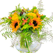 Bright and uplifting, this sunflower and lime-green bouquet from Tufnell Park radiates pure North London joy. Towering sunflowers, with their golden halos and striking dark centers, are the stars-immediately drawing the eye and filling the space with vibrant energy. Fluffy yellow filler blooms mirror the sunlight, threading through the arrangement, while small, playful coral-orange flowers add a contemporary note of surprise and delight. Lush green ferns surround the blooms, their texture soft and wild, as if gathered during a stroll through Tufnell Park's green spaces. Wisps of bluish eucalyptus add a modern edge and evoke the artistic spirit of the local community. The whole ensemble stands proudly in a spherical, clear glass vase, revealing stems criss-crossing in fresh water-a nod to the bouquet's natural freshness and superior craftsmanship. Light bounces from every petal and frond, creating an aura of happiness and calm, perfect for congratulating friends, cheering up a new neighbour, or brightening a room on a rainy Camden day. With each bloom thoughtfully chosen and arranged, this bouquet embodies Tufnell Park's welcoming, creative heart.