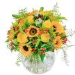 Glowing with the vivacity of a Tufnell Park afternoon, this bouquet reflects the lively spirit of local gardens and neighbourhood gatherings. Sunflowers with bold, dark centers anchor the arrangement, their wide, luminous petals spreading warmth and optimism in every direction. Intertwined, creamy yellow roses open in gentle spirals, bearing the quiet joy of celebration-a flourish familiar to birthday tables or doorstep surprises along Campdale Road. Scarlet red berries and playful orange blossoms punctuate the lush green backdrop, their whimsical contrast adding depth and energy. Wisps of fern trail and curl at the edges, mimicking the lively movement of a breeze sifting through Highgate's leafy avenues. Cradled in a classic rounded glass vase, the stems form an organic tangle, allowing light to filter through and magnify the bouquet's inviting palette. The overall effect is delightfully fresh and sweet, the scent of greenery weaving a subtle background. Crafted with care by a dedicated local team, this arrangement is ideal for bringing radiant cheer into any Tufnell Park home, making every occasion brighter and more memorable.