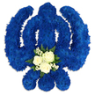 A bold Sikh Khanda floral tribute fills the frame, its sacred form carefully shaped from a sea of royal blue petals against an immaculate white background. The emblem's familiar structure-the central vertical sword, the encircling chakkar, and the two symmetrical kirpans sweeping outwards-has been translated with precision into floristry, using countless small blue chrysanthemums or similar button flowers. Packed tightly together, these blooms create a dense, velour-like surface that appears both soft and resolute, echoing the strength and unity symbolised by the Khanda itself. Light from above and slightly to one side sends a gentle sheen across the petals, producing subtle shadows along the inner curves and adding depth, as though the floral symbol gently rises from the backdrop. At the lower centre of the design, where the sword's base meets the curve of the circle, a small bouquet of contrasting flowers draws the eye. Three creamy white roses open serenely at the centre, cradled by tiny white filler flowers and framed with glossy dark green leaves. This peaceful cluster of white and green offers a quiet respite within the powerful blue, suggesting purity, remembrance, and compassion. The overall mood is calm yet deeply reverent-an arrangement that could accompany a Sikh funeral or memorial in the Tufnell Park area, perhaps delivered to a family home off Fortess Road or to a nearby gathering place. It feels like the work of a skilled local florist who understands both the visual precision required to form the Khanda and the emotional sensitivity needed when creating a farewell tribute that honours faith, heritage, and the memory of a loved one.