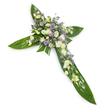 A solemn, elegantly crafted floral cross photographed on a clean white background from a gentle overhead angle, the composition isolated to focus on its quiet dignity. Broad, glossy tropical leaves - think Ti leaves with visible central veins and a satiny sheen - form the structural arms and central spine of the Christian cross, their rich green a calming, verdant foundation. At the heart and running along each arm sits a densely packed spray of soft white and creamy ivory blooms: ruffled lisianthus with their layered, silk-like petals and a handful of small, round white chrysanthemums or spray roses that add a tender, cloud-like texture. Interspersed through the pale palette are delicate clusters of powdery lavender or light purple accent flowers, likely limonium or tiny asters, which give a whisper of contrast and depth without disturbing the arrangement's serene tone. Finer sprigs of pale green filler foliage thread through the flowers, adding subtle movement and a natural, garden-fresh softness. The lighting is even and gentle, catching the gloss of the leaves and the sheer translucence of the lisianthus petals, while the white backdrop keeps the focus on shape, texture, and colour. This piece reads as a traditional sympathy tribute - restrained, respectful, and contemplative - suitable for a funeral chapel, wake, or graveside service. As a local florist familiar with Tufnell Park and nearby Archway, I see this arrangement as a visual pause: a comforting, unadorned statement of remembrance that speaks of peace, faith, and enduring love without the need for words.