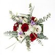 Gazing down upon this bouquet, it is as if the vibrant heart of Tufnell Park is distilled into a single, harmonious arrangement. The velvety red roses catch the light, unfolding with classic glamour and depth-each bloom pulse with warmth, reminiscent of romantic evenings or milestone moments celebrated along Brecknock Road. Radiating around them, pure white gerbera daisies and feathery white spray chrysanthemums bathe the bouquet in an uplifting glow evoking the inviting, communal spirit of local neighbourhood gatherings. Sprigs of cool-toned eucalyptus arch outward, their round, silvery leaves bringing an earthy-modern touch and a whisper of forest freshness, like an early morning breath at Tufnell Park. Between the bolder hues, pale lilac lisianthus slip in, their gentle petals soothing and elevating the entire palette. Every stem is artfully placed so each flower shines; the arrangement feels intentional but relaxed, bathed in soft, natural light that enhances every shade and contour. This bouquet is an inviting gesture for heartfelt anniversaries, special birthdays, or simply to brighten a home on Dartmouth Park Hill-a beautiful example of Tufnell Park's local floral artistry, ready for same-day delivery or a cherished centrepiece at your next gathering.