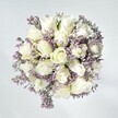 This bouquet captures Tufnell Park's gentle tranquility as if gathering the first light of dawn in petal form. Soft white roses, their plush, layered blossoms opening in perfect spiral whorls, form the arrangement's elegant heart-each flower a symbol of sincerity and fresh chapters. Intertwined with the roses are delicate sprays of pale lavender statice, with each cluster's fine texture adding lacy movement, reminiscent of quiet mornings near local haunts like the Tufnell Park Farmers Market. A white-washed backdrop and streams of natural light illuminate every bloom, amplifying the sense of purity and freshness, while hints of green foliage peek from beneath, grounding the palette. The overall effect is calm, uplifting-ideal for offering solace, sharing congratulations, or lending graceful beauty to local homes and gatherings. Meticulously styled by a Tufnell Park florist, this bouquet speaks with the softest voice, evoking comfort, promise, and lasting peace that lingers long after the flowers are delivered.