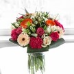 Captured in bright, lively daylight, this bouquet from Tufnell Park feels like a moment of pure celebration-vivid, abundant, and full of emotion. Energetic orange gerberas bloom alongside soft blush roses, their colours warming any corner of a home near Fortess Road. Magenta and fuchsia carnations add plush drama with their rich textures, while creamy ivory roses and gentle peach gerberas bring a tender, sophisticated balance. Crisp, glossy greenery frames the bouquet, conveying freshness and a sense of growth evocative of the local community gardens. The light seems to illuminate every detail-the delicate veins of each petal, the interplay between soft and bold hues-causing the entire arrangement to glow with happiness. Arranged with a skilled florist's touch just steps from Tufnell Park station, this bouquet is crafted for marking milestones, offering joy, or simply bringing a smile to someone's day. With every stem chosen in harmony and every bloom placed with intention, it stands as both a burst of cheerful energy and a testament to local artistry. This is a bouquet that brings together celebration and comfort, echoing the vibrancy and neighbourly spirit unique to Tufnell Park.