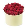 In soft morning light, this luxurious bouquet sits crowned by a round, pale cream cylindrical box with a matte finish. Inside, approximately twenty-four velvety crimson roses rise in a dense, domed cluster, their petals tightly furled as if freshly opened and at the peak of their beauty. The blooms fill the box from edge to edge, with only a hint of dark green foliage peeking through to add a natural breath of contrast. The arrangement is photographed from a slightly elevated, three-quarter angle, against a pristine white backdrop that lets the rich colour and sculptural form take centre stage. The overall feel is elegant and romantic, a premium gift that whispers of love and thoughtful intention, perfect for anniversaries, Valentine's gestures, or a milestone surprise. Crafted by Flowers Tufnell Park, this piece embodies the skill of a local florist who knows the cadence of celebrations in North London-from Kentish Town to Gospel Oak and beyond. For those seeking a reliable, heartfelt delivery, it's available for same-day delivery across Tufnell Park and nearby streets, ensuring a graceful keepsake arrives promptly to brighten a special day.