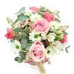 A beautifully composed blush-pink hatbox arrangement is photographed from a slightly overhead angle, standing out clearly against a pure white background and conveying a mood of gentle romance that suits Tufnell Park's relaxed, village-like atmosphere. The hatbox itself is a soft, dusty pink tone, finished with a slim satin ribbon in a deeper pink shade tied neatly around its base. From the ribbon hangs a small, cream-coloured tag with a simple logo, the kind you might spot on a carefully wrapped bouquet from a favourite Tufnell Park florist. Rising above the rim, the flowers are arranged in a full, rounded dome. Light pink roses, some in full bloom and others just opening, provide the main structure, their velvety, spiralling petals creating focal points that draw the eye. Nestled among them are white daisy-like chrysanthemums, each with a bright green centre that injects a touch of freshness and cheerful contrast, much like a patch of sunlit lawn in nearby Tufnell Park Gardens. Delicate white alstroemeria blooms, decorated with fine purplish-red streaks and speckles, weave gently through the design, adding both elegance and fine detail. The foliage enhances the natural look: rounded, silvery eucalyptus leaves create a cool, misty backdrop, while longer, darker green leaves add depth and a slightly wild, garden-grown feel. Tiny reddish-brown buds or berry-like clusters punctuate the greenery, giving warmth and subtle texture. The overall arrangement feels poised yet approachable, the kind of floral gift that would look perfect on a dining table in a Tufnell Park townhouse or a windowsill overlooking Dalmeny Avenue, ideal for birthdays, anniversaries, or a quiet gesture of appreciation delivered locally the very same day.