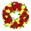 A meticulously crafted circular funeral wreath is displayed against a plain, bright white background, making its colours and textures appear especially vivid. The wreath is tightly packed with a harmonious blend of deep red roses and sunny yellow chrysanthemums, leaving no empty spaces along the ring and creating a strong impression of completeness and care. Each rose is in full bloom, with layers of velvety petals spiralling towards the centre, their tones shifting gently between classic crimson and darker burgundy, suggesting depth of feeling and solemn respect. Scattered evenly among the roses are small clusters of yellow chrysanthemums, their soft, many-petalled heads bringing a lighter, uplifting note to the arrangement. These cheerful yellow flowers sit slightly above and between the roses, giving the wreath a textured, almost quilted appearance that invites the imagination to feel the contrast between smooth rose petals and the fluffier chrysanthemum centres. The flowers are framed and supported by a rich collar of green foliage, likely a mix of salal, ruscus and eucalyptus, in shades from glossy, vibrant green to cooler, silvery-green. The leaves radiate gently outward, softening the outline of the wreath while preserving a clear, round shape with an open centre that symbolises eternity and ongoing remembrance. The neutral studio lighting casts no harsh shadows, focusing attention on the natural beauty of the blossoms. This timeless red and yellow floral tribute would be a fitting choice for families in Tufnell Park marking a funeral, wake or memorial service, offering a dignified expression of sympathy and enduring love.