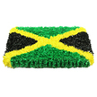 The photograph presents a beautifully composed rectangular tribute that transforms the Jamaican flag into a textured, floral-style artwork suitable for a dignified farewell or cultural memorial in Tufnell Park. The piece is set against a brilliant white background, which makes the colours appear especially vivid and clean, as though freshly prepared for same-day delivery. At the centre of the design is a bold golden yellow diagonal cross, its X-shape cutting decisively from corner to corner. This cross is made of countless small, ruffled fragments that suggest masses of tiny petals or fabric rosettes, all carefully pressed together to form a continuous band of bright, hopeful colour. In the upper and lower triangles created by the cross, rich green segments echo the look of densely packed chrysanthemums or mossy foliage, conjuring the freshness of local gardens and tree-lined streets near Tufnell Park's bustling centre. On the left and right sides, deep black triangles complete the flag motif, their surface slightly more matte and shadowed, bringing a sense of calm, solemn reflection. The tribute itself appears solid and slightly raised, almost like a framed work of art or ceremonial panel rather than a simple arrangement, its straight edges and balanced proportions lending a sense of order and respect. Soft, consistent lighting reveals every delicate fold and curve, highlighting the hand-made nature of the design and the care taken in crafting it. Altogether, the piece embodies pride, remembrance, and cultural identity, a powerful and comforting symbol for families marking a life well lived and ties to Jamaica within the Tufnell Park community.