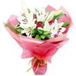 A luxurious, hand-tied bouquet of white Oriental lilies and deep red roses is pictured upright against a pure white background, the kind of elegant design that might be prepared in a small independent florist near Tufnell Park station. The lilies are the stars: large, trumpet-shaped flowers with pristine white petals that flare open gracefully, each bloom showcasing a cluster of prominent, dark brown anthers held on slender filaments above soft green centres. Some lilies are in full, impressive bloom, while others remain as smooth, tapered buds with pale green tips, adding structure and a promise of continued flowering. Tucked between these dramatic blooms are numerous red rosebuds and partially open roses, their velvety, tightly coiled petals forming rich, romantic accents of deep crimson that contrast beautifully with the cool white lilies. Around the flowers, a generous collar of dark green foliage and finer, linear leaves creates a lush, textured background, expanding the bouquet's silhouette and enhancing its sense of abundance. The stems are gathered and wrapped in layers of bright pink, shiny cellophane, the translucent material folding and crinkling into soft, billowing shapes that reflect the light and suggest celebration. At the base, a slim lime green ribbon is tied neatly in a small bow or knot, with short trailing ends that introduce a fresh, modern touch. The composition feels joyful yet classic, ideal for birthdays, anniversaries, Mother's Day surprises, or a heartfelt thank-you delivered to homes and offices throughout Tufnell Park, Kentish Town, and the surrounding North London neighbourhoods.