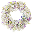 A serene, circular funeral wreath appears suspended against a pure white background, crafted in a style that feels both modern and timeless, like a thoughtful tribute prepared in a Tufnell Park workshop on a still morning. The main body of the wreath is made entirely of white baby's breath, the Gypsophila arranged so densely that it forms a thick, cushiony ring of tiny blossoms. Each minuscule flower contributes to an overall texture that looks feathery and cloud-like, softening the lines of the circle. Threaded among this mist of white are carefully positioned lisianthus blooms, chosen for their gently ruffled petals and painterly colour. The lisianthus petals open in layers of clean white, each outer edge kissed with lavender and violet tones that deepen in some places to a rich purple, as though shaded by hand. Some faces are fully open, displaying darker centres that add contrast and depth; others remain in bud, with hints of green, cream, and pale yellow at their bases, suggesting freshness and recent cutting. The interplay between the tiny Gypsophila and the larger, more sculptural lisianthus adds rhythm and movement to the design, encouraging the gaze to follow the curve of the wreath. The central opening is perfectly round and empty, emphasising the symbolism of the circle as an emblem of continuity, unity, and everlasting love. The overall mood is one of quiet reverence and consolation, ideal for a funeral, memorial service, or graveside farewell in and around Tufnell Park, where a gentle, beautifully made floral wreath can convey sympathy and remembrance when words feel insufficient.