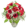 A classic red and white bouquet is displayed in a simple clear glass vase, photographed against a flawless white background that makes its colours appear especially vivid. At its centre, several deep red roses with tightly coiled, velvety petals rise confidently, each bloom echoing the traditional language of love and devotion. Surrounding them in generous clusters are red carnations, slightly brighter in tone yet equally rich, their multiple ruffled petals creating a soft, billowing texture that fills out the arrangement. Woven all through the design is a mist of delicate white baby's breath, thousands of tiny blossoms forming a fine, airy veil that softens the look and adds an almost ethereal lightness to the bouquet. Fresh green leaves are nestled between the blooms, from the dark, glossy foliage of the roses to more rounded, eucalyptus-style leaves with a cool, muted green shade, offering gentle contrast and structure without distracting from the flowers. The vase, clear and quietly elegant with a faint flare at the rim, reveals cleanly cut stems resting in clear water, a subtle sign of professional care and freshness. Under bright, even light, the reds glow warmly while the whites appear crisp and pure, giving the whole composition a feeling of poised celebration. It is the kind of arrangement you could imagine brightening a breakfast table in a flat off Fortess Road, resting on a windowsill overlooking Tufnell Park, or being delivered as a meaningful gesture of love, appreciation, or remembrance within the local community.