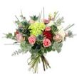A bright, hand-tied bouquet photographed against a pure white backdrop, its colours and textures shown with crisp clarity. At the centre sits a generous, lime-green hydrangea, its clustered tiny petals forming a soft, cloud-like mound that immediately draws the eye. Surrounding that luminous heart are several rose varieties: deep, velvety red roses whose tightly furled petals suggest classic romance, and gentler blush-pink and cream roses that open slightly to reveal layers of delicate, satiny petal. Scattered through the composition are coral-pink carnations, their ruffled, frilly edges adding playful texture and warm contrast. Interspersed for an architectural accent are steely blue-grey Eryngium thistles - spiky, star-shaped blooms that bring a modern, slightly wild silhouette and a cool blue counterpoint to the warmer tones.
The bouquet is richly layered with foliage: round, silvery-green eucalyptus leaves lend a soft, aromatic backdrop while long, narrow blades of bright green grass or filler foliage rise through the arrangement to add height and movement. Light from above catches the hydrangea and rose petals, creating subtle highlights and a sense of freshness as if the stems were just cut. The base is neatly gathered and tied with natural-coloured twine, the cut green stems visible and reassuringly fresh.
This arrangement reads as both elegant and carefree - suitable for surprising a parent on Mother's Day, brightening a birthday table, or simply lifting a room. There's a tactile richness to it: the velvet, the ruffle, the spike and the soft leaf - all balanced into a joyful, contemporary bouquet that feels handcrafted and attentive to detail.