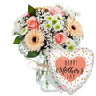 A softly lit Mother's Day gift arrangement is displayed against a pure white background, drawing all attention to the colours and shapes of the flowers and the joyful balloon, as if set on a pristine kitchen table in a Tufnell Park townhouse. At the heart of the image stands a clear glass vase, modest in design yet full of character thanks to a slim band of rustic twine knotted around its neck, giving the feel of something lovingly assembled rather than mass-produced. The vase overflows with a rounded bouquet of fresh blooms: peach and blush-pink roses, some fully open and layered like rosettes, others still cupped, share space with cheerful peach gerbera daisies whose generous petals fan out around dark central disks. Scattered throughout the arrangement are billowy tufts of white baby's breath, their tiny blossoms forming a delicate halo, while compact white chrysanthemums with subtle green centres provide structure and a clean, modern contrast. A collar of lush green foliage, likely common florist greens, peeks out around the blooms, giving depth and a sense of movement as if the bouquet has just been turned on a workbench in a local Tufnell Park flower shop. Slightly obscured by the flowers is a small white greeting card bearing a colourful, partly hidden inscription that hints at a personal Mother's Day message. To the lower right, a large heart-shaped foil balloon leans towards the bouquet. Its white surface is sprinkled with metallic gold and silver dots that glint like celebratory confetti, and a central peach heart frames the bold black words HAPPY Mother's DAY, with Mother's written in a flowing, calligraphic style. Together, the fresh flowers, handwritten card and playful balloon evoke affection, gratitude and celebration, a scene that feels ready for same-day delivery to mums across Tufnell Park and its quiet side streets.