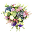 Epitomizing elegance with a playful touch, this hand-tied bouquet captures the essence of Tufnell Park's eclectic charm and leafy neighbourhood ambience. Voluminous hydrangeas in shades from misty indigo to soft teal anchor the composition, their blooms plush and inviting. Blossoming throughout are soft lilac and creamy white roses, their petals unfurling in gentle, spiraled waves, evoking both romance and quiet sophistication. Bright white, densely layered ranunculus nestle harmoniously among slender, pale yellow lisianthus buds-these delicate forms recall mornings spent wandering Tufnell Park's tranquil green spaces. Sprays of vivid fuchsia-pink flowers add lively, joyful bursts of colour, while feathery, blush-pink astilbe plumes float around the rim, their airy movement reminiscent of wild meadow blooms. Intricate light green and white filler flowers, almost translucent in nature, lend fine texture and delicacy amid glossy, emerald leaves. At the base, a sumptuous royal purple satin ribbon binds the stems with a flourish fit for a special occasion. The result is a full-bodied, radiant bouquet that feels fresh from a local Tufnell Park garden-perfect to mark milestones, offer congratulations, or simply brighten a home with its luxurious palette and fragrant, verdant spirit.