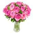 A generous, tightly clustered bouquet of roughly two dozen fresh pink roses sits in a simple clear glass vase, its stems visible through the clean water. Each rose opens in delicate spirals: the heart of every bloom holds a richer fuchsia or magenta tone that softens outward to blush pink and, on some outer petals, a hint of creamy ivory. The heads are arranged closely to create a rounded, domed silhouette, while deep green, glossy leaves peek between the roses and along the base, adding texture and contrast. Bright, even lighting picks out the satiny sheen and subtle veining of the petals, making each curl and fold pronounced as if you might feel the velvet softness beneath your fingers. There is an imagined perfume - a sweet, slightly fruity rose scent that suggests early summer mornings and freshly cut flowers gathered from a neighbourhood garden. The vase's transparency and the visible trimmed stems lend a sense of honesty and freshness to the composition, while the pristine white backdrop keeps the focus purely on the blossoms. This arrangement reads as classic and affectionate: ideal for anniversaries, birthdays, or a spontaneous message of love and appreciation. As a local florist familiar with Tufnell Park's quieter, leafy streets, I picture these blooms brightening a mantelpiece on Fortess Road or delivered to a cosy flat near Dartmouth Park, carrying both the visual richness and the warm intention behind every stem.