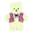 In this photograph, a three-dimensional teddy bear made entirely from fresh flowers sits gracefully against a bright white background, its design both intricate and soothing. The bear's body is constructed from countless creamy white chrysanthemums, their small, tightly packed petals creating the illusion of thick, velvety fur over the head, rounded ears, arms, and feet. The blossoms are arranged so smoothly that the contours of the bear's cuddly shape are clear and soft, as if it could have been lifted straight from a child's bedroom in Tufnell Park and transformed into blooms. Two small, dark floral centres serve as gentle, button-like eyes, and a matching darker piece shapes the nose, while a slight curve below them hints at a calm, comforting smile. Draped neatly across the bear's front is a vivid purple and mauve floral vest, the pattern carefully constructed so that the lapels stand out in sharp, triangular lines against the pale body, adding character and a hint of formality. At the neck, a delicate lavender mesh bow sits like a bow tie, its fine net catching the light and offering a soft, airy contrast to the dense floral 'fur' beneath. The imagined fragrance is subtle and fresh, like stepping into a quiet florist's shop off Junction Road early in the day. This floral teddy bear is a bespoke funeral and sympathy tribute, created to convey deep love, innocence, and remembrance, particularly meaningful when honouring a child or someone forever linked with tenderness. It reflects the kind of thoughtful, hand-crafted memorial arrangement chosen by families in Tufnell Park who wish to send a message of comfort that feels both personal and deeply heartfelt.